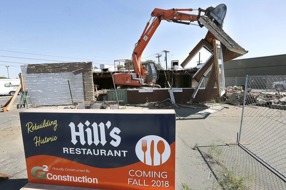 Steve Campbell of G2 Construction uses an excavator to move the former front entryway of Hill's Restaurant into the fenced off parking lot for crunching on the first day of demolition of the fire damaged building. The popular eatery is being rebuilt and expected to re-open later this year.