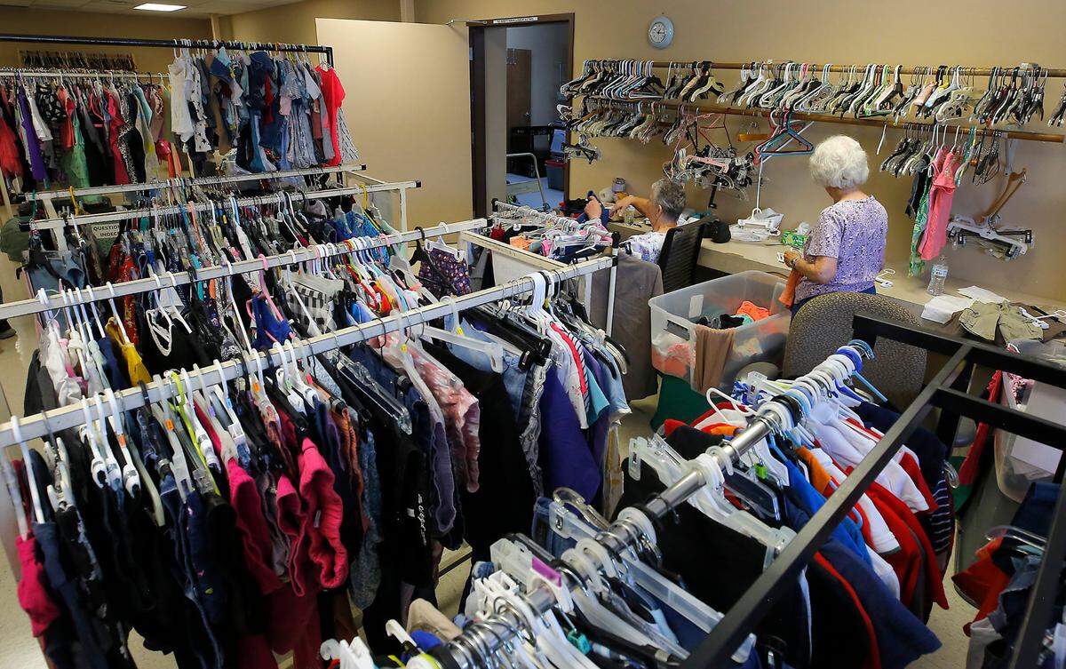 Volunteers sort donated clothing for distribution at the St. Vincent de Paul Food Bank facility at 215 S. 6th Ave. in Pasco.
