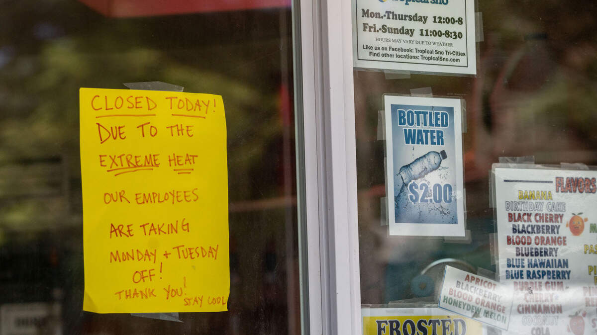 A sign in the window of the Tropical Sno stand in Howard Amon park in Richland states it will be closed Monday and Tuesday due to the extreme heat. Some Tri-Cities businesses have chosen to close down in an effort to avoid working in temperatures exceeding 110 degrees.
