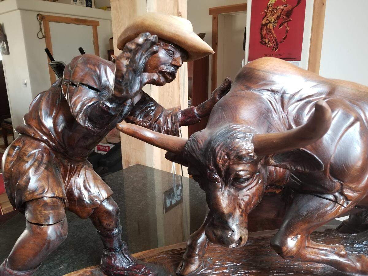 The Sisters Rodeo organization honored Rowdy Barry for 26 years of work with a wood carving of him fighting a bull.