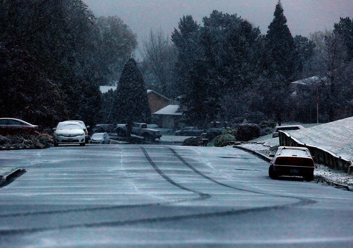 A single set of tire tracks are visible on the pavement in this Kennewick neighborhood early Monday morning as a spring snowstorm coats the Mid-Columbia.