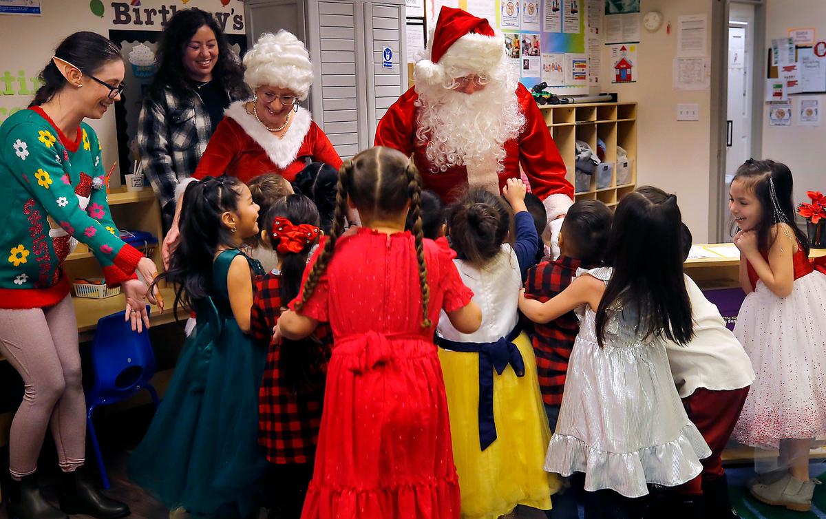 Santa and Mrs. Claus receive an enthusiastic greeting from students at the Sunset Ridge Benton Franklin Head Start in Pasco. Santa was Bob Schuetz, Energy Northwest CEO, and his wife, Brenda, is Mrs. Claus. Head Start employee Jessica Stone joins the party as a workshop elf.