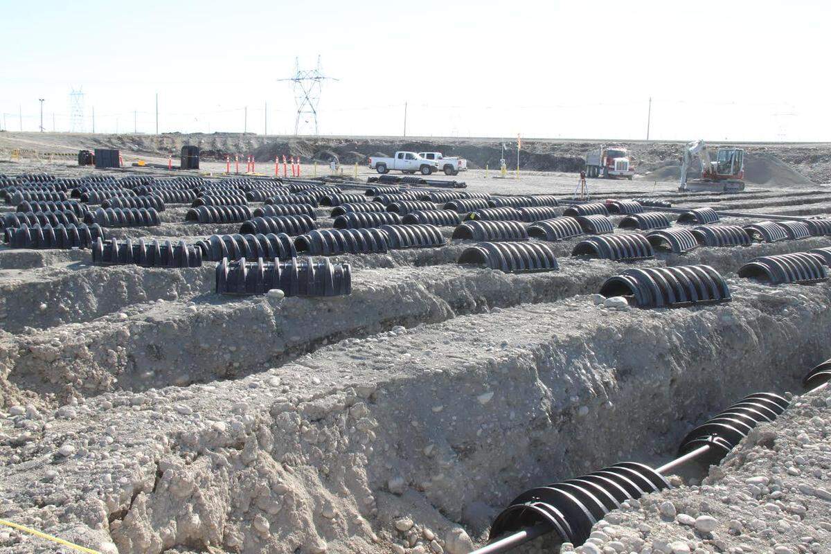 Hanford workers installed culverts and piping to saturate soil with water just below the ground to test a new way of removing chromium contamination near the Columbia River.