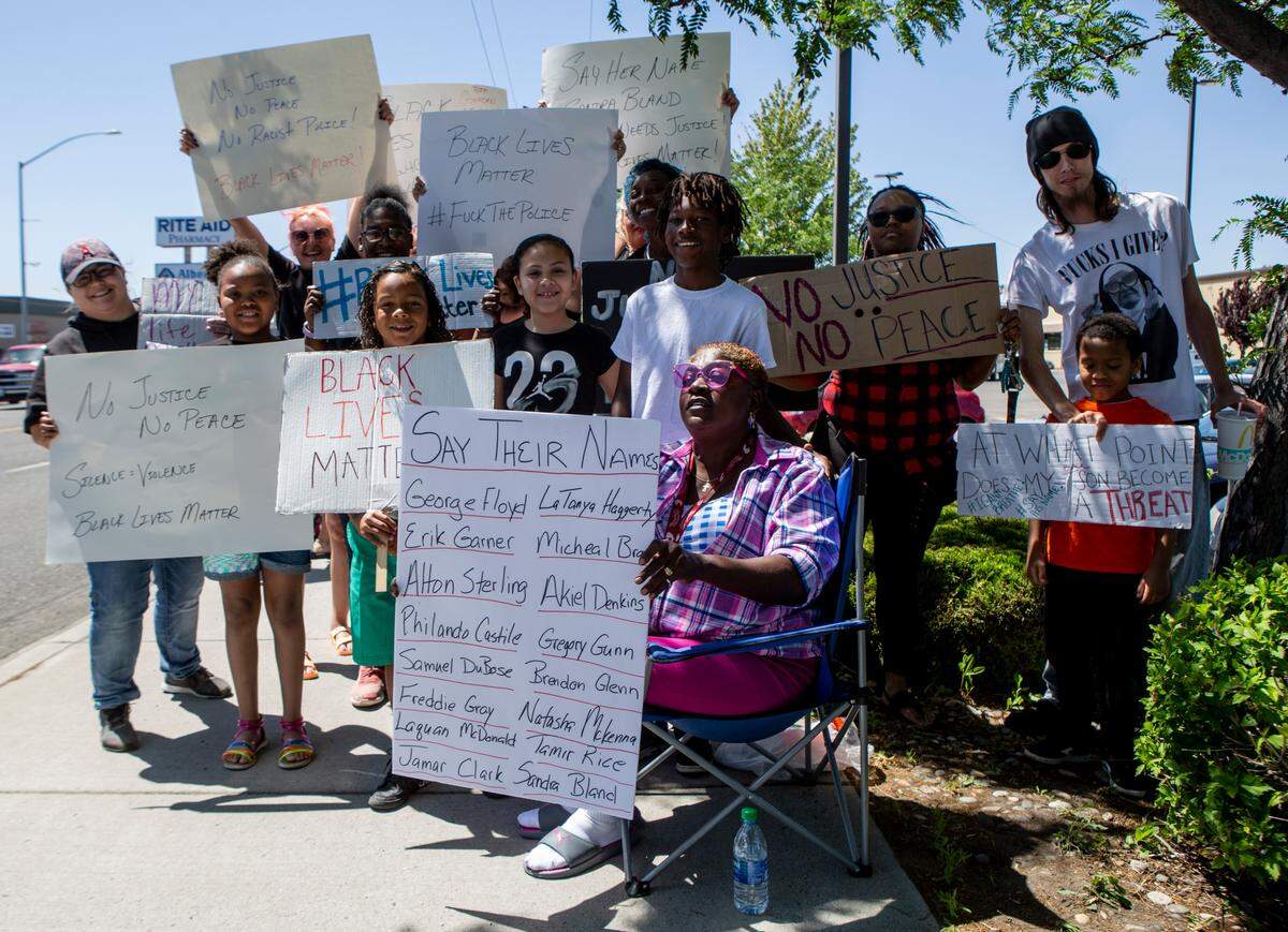 Nadine Gladney, 59, poses for a portrait with her grandkids, family and friends near the corner of Court Street and North 20th Street in Pasco on Sunday during a peaceful protest against police brutality and violence against black people. Demonstrations occurred across the nation over the weekend, sparked by the death of George Floyd at the hands of Minneapolis police.