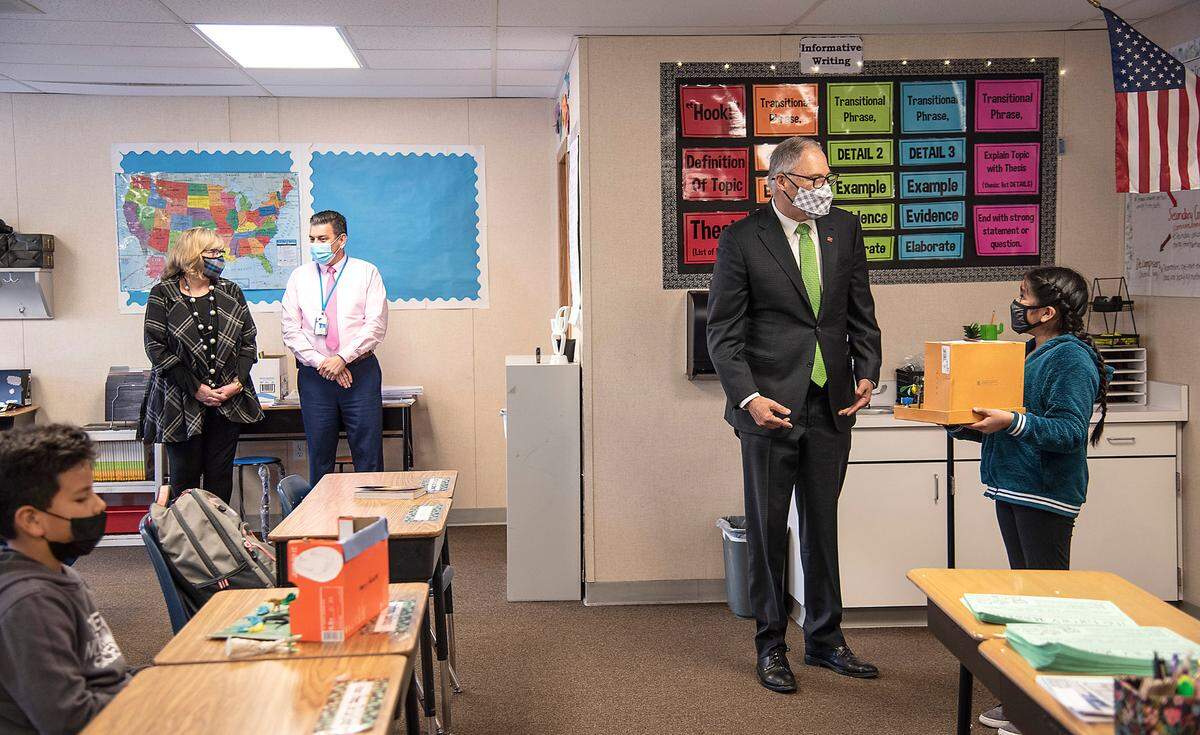 Gov. Jay Inslee visits with student Yareli De La Cruz Guzman in teacher Maria Chavez’s fifth-grade classroom Robert Frost Elementary School in Pasco during his visit to the Tri-Cities on Tuesday.