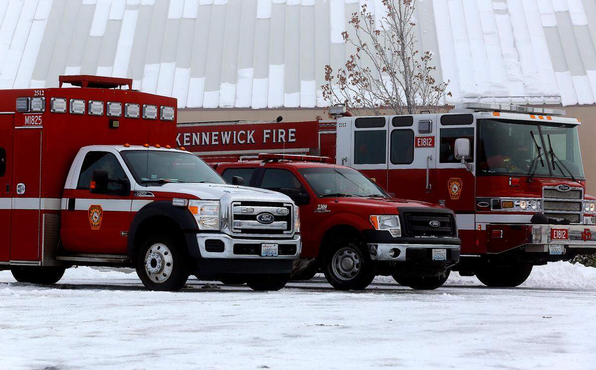 The Kennewick Fire Department stages their equipment and personnel at the Southridge Sports & Events Complex as law enforcement officials search Southridge High School after receiving a report of a gun on campus.