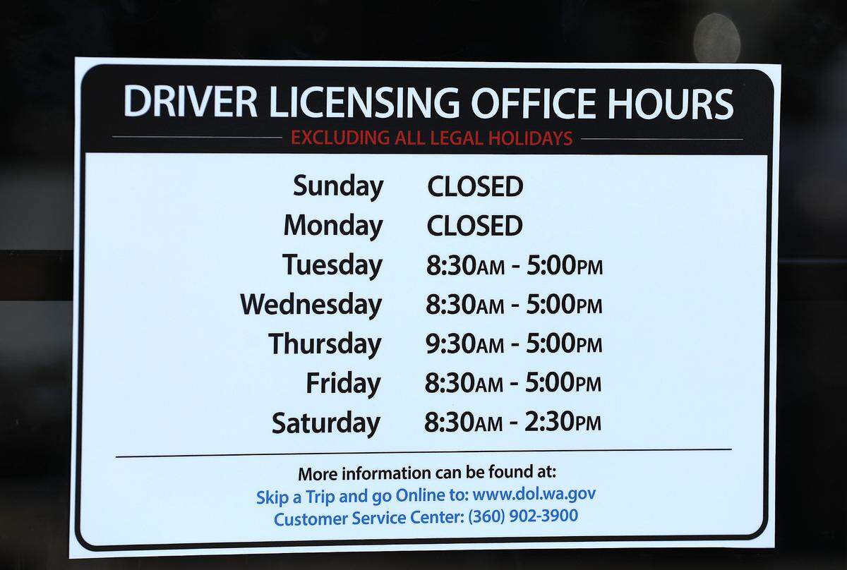 Office hours sign posted on the front door of the Washington State Department of Licensing Drive Licensing office at 3311 W. Clearwater Ave. in Kennewick.