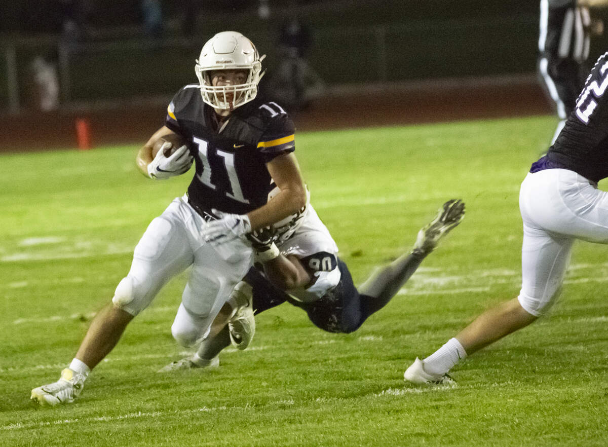 Hanford’s Jared Devine (11) drives the ball down as Chiawana’s AJ Vongphachanh (90) attempts to stop him during a Mid-Columbia Conference high school football game at Fran Rish in Richland on Friday. Hanford defeated Chiawana 34-21.