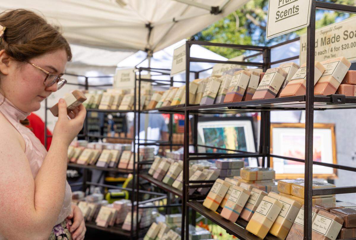 Vendors at the Art in the Park Festival create scented handmade soaps and other unique handmade crafts
