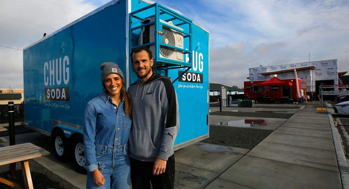 Rachel and Kevin Magelsen stand next to their food trailer called Chug Soda, while setting it up Wednesday in the Edison Street Food Park in Kennewick. They are the third mobile business to occupy a space at the venue on West Okanogan Avenue and North Edison Street.