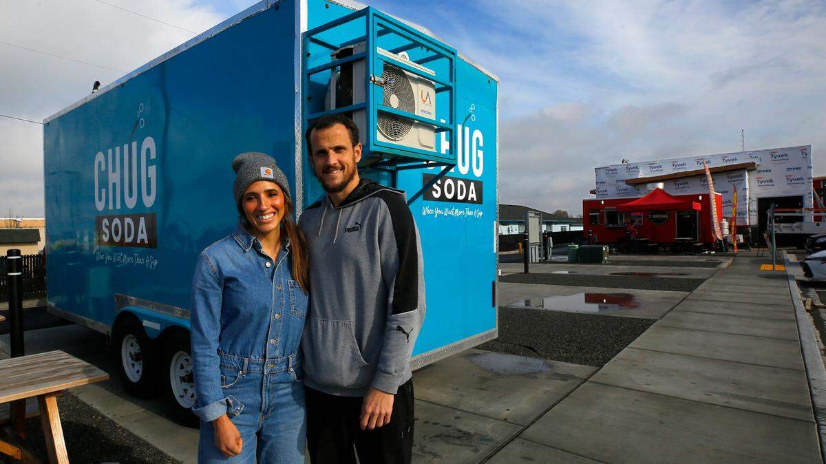 Rachel and Kevin Magelsen stand next to their food trailer called Chug Soda, while setting it up Wednesday in the Edison Street Food Park in Kennewick. They are the third mobile business to occupy a space at the venue on West Okanogan Avenue and North Edison Street.