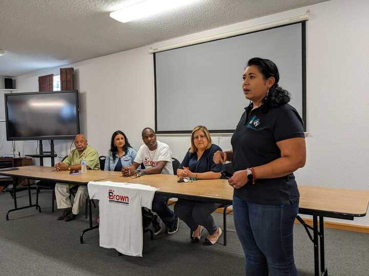 Recently appointed Pasco School Board member Rosa Torres, right, speaks to a crowd of civic, religious and labor leaders at a rally to support Irving Brown Sr., the Black city councilman who was the target of a racist message last week.