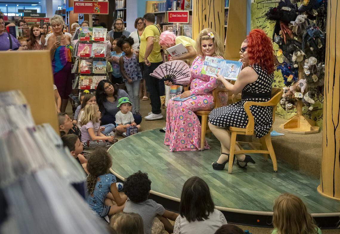 Hundreds of people arrived for Drag Queen Story Time to hear stories read by Sugar, left, and Tatiana Rexia in Kennewick on Saturday.