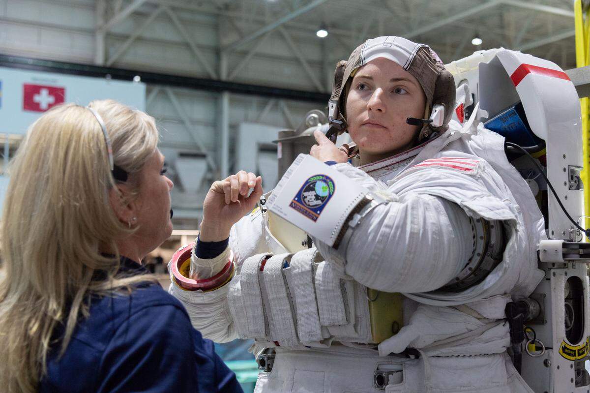 NASA astronaut Kayla Barron of Richland is helped into a spacesuit prior to underwater spacewalk training at NASA Johnson Space Center’s Neutral Buoyancy Laboratory in Houston.