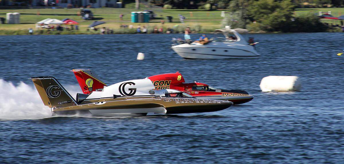 J. Michael Kelly in the U-8 Miss Beacon Electric unlimited hydrolane edges out Andrew Tate in the U-91 Goodman Real Estate boat at the finish line for Heat 2B Saturday on the Columbia River.