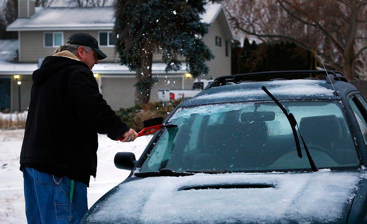 James Saylor scrapes off ice from overnight freezing rain encrusting his car early Wednesday morning in the 1800 block of South Sheppard Street in Kennewick. Saylor said he started 15 minutes earlier than normal to warm up his Subaru and scrape the windows so he could arrive on time for his shift at the Kennewick Winco grocery store.