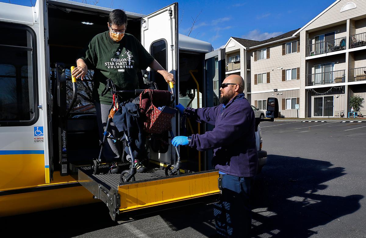 Jane Campbell is helped by Dial-A-Ride driver David Alcaraz on her return trip to her Richland apartment complex following a medical appointment in Pasco.