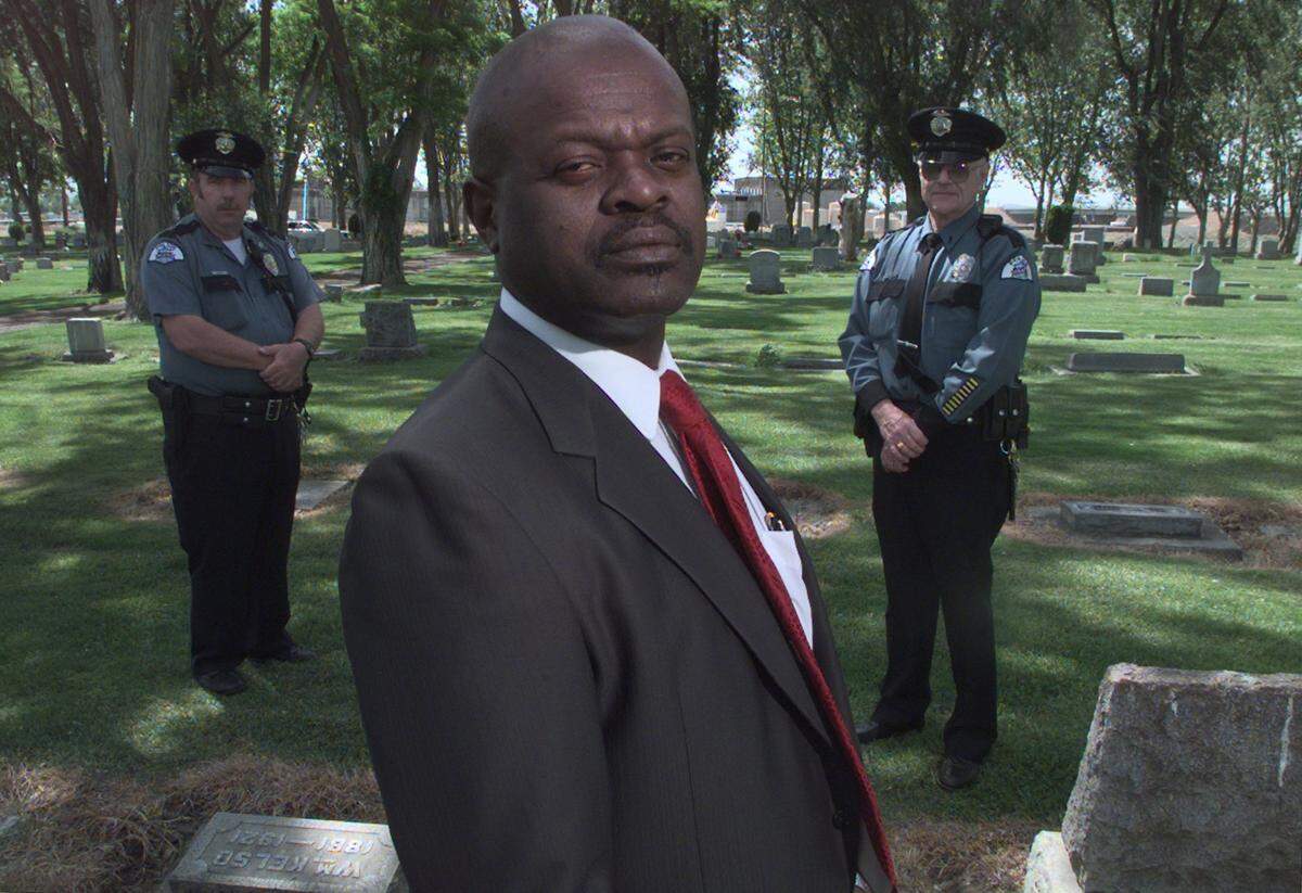 Dwight Davison, a Pasco policeman, left, Edgar Hargrow, a former Pasco city councilman, and Bruce McCord a reserve lieutenant for the Pasco police, are working to get a headstone for Jesse Barrick’s grave.