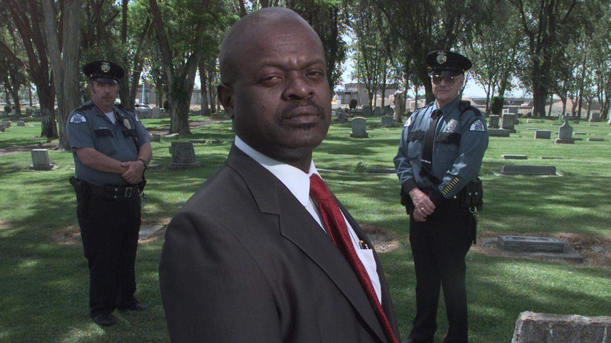 Dwight Davison, a Pasco policeman, left, Edgar Hargrow, a former Pasco city councilman, and Bruce McCord a reserve lieutenant for the Pasco police, are working to get a headstone for Jesse Barrick’s grave.