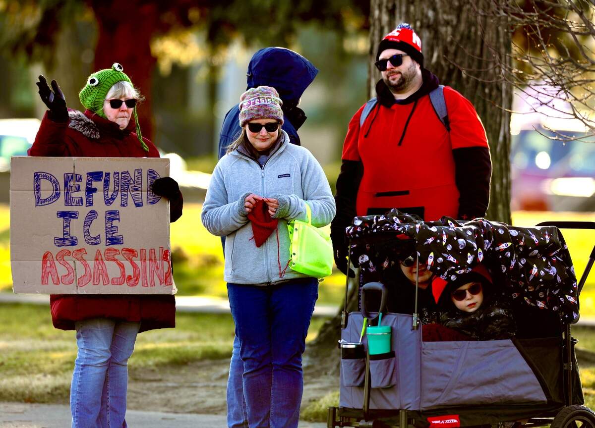 About 120 protesters waved signs at drivers along George Washington Way at John Dam Plaza in Richland on Sunday after the weekend killing of Alex Pretti, a nurse in Minneapolis, by immigration agents.