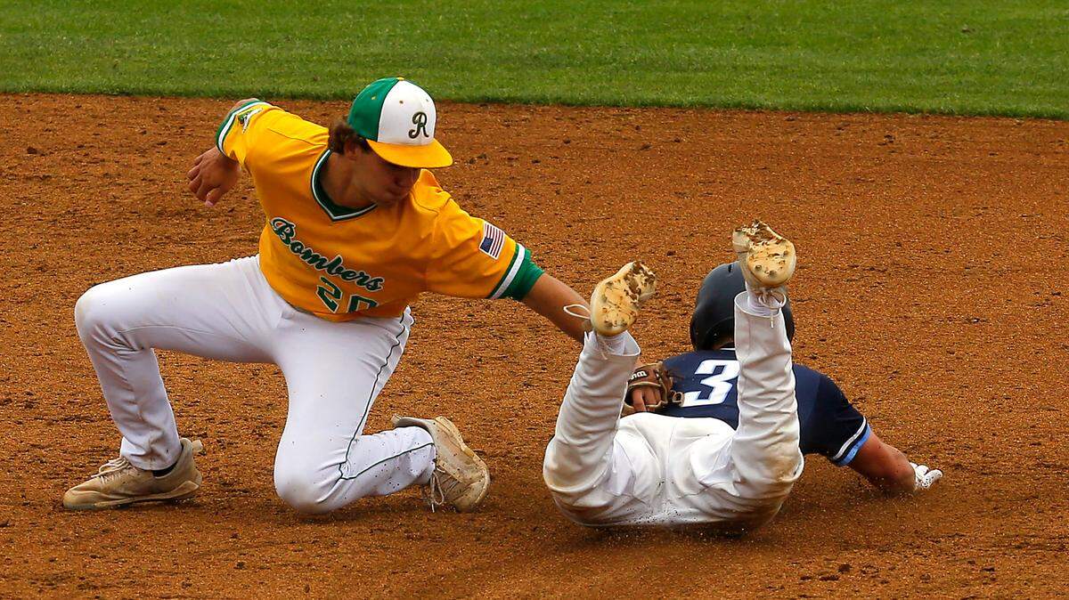 Richland shortstop Jase Vopalensky (20) appears to get the the tag on Olympia base runner Brody Phinney as he slides headfirst into second base during Friday’s state 4A playoff game in Pasco. Phinney was called safe on the play.
