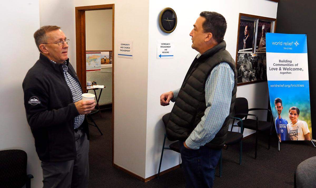 Robb Rennix, left, World Relief Tri-Cities church and community engagement manager, talks with Ken Primus, director of World Relief Tri-Cities, at the nonprofit’s Richland office. World Relief has helped nearly 1,900 refugees in Tri-Cities from 2019 to 2024. About 1,100 of them are Ukrainians.