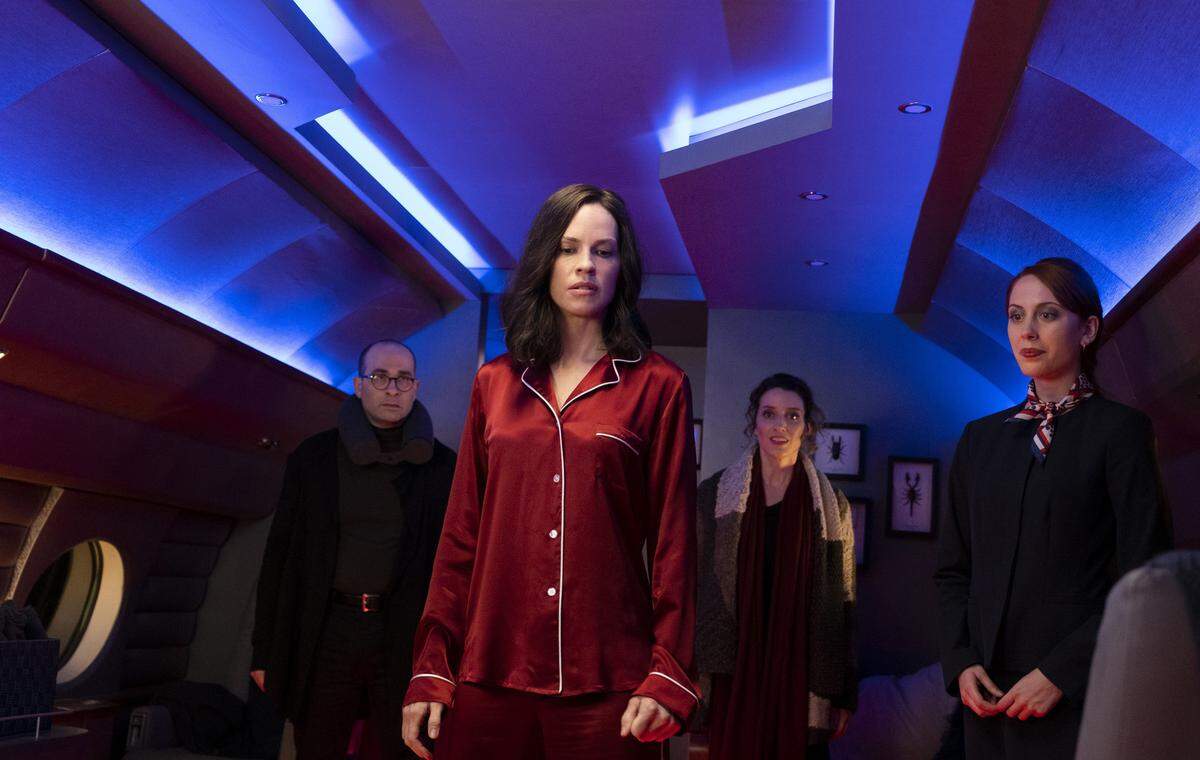 This image released by Universal Pictures shows Hilary Swank, center, in a scene from “The Hunt.” (Patti Perret/Universal Pictures via AP)