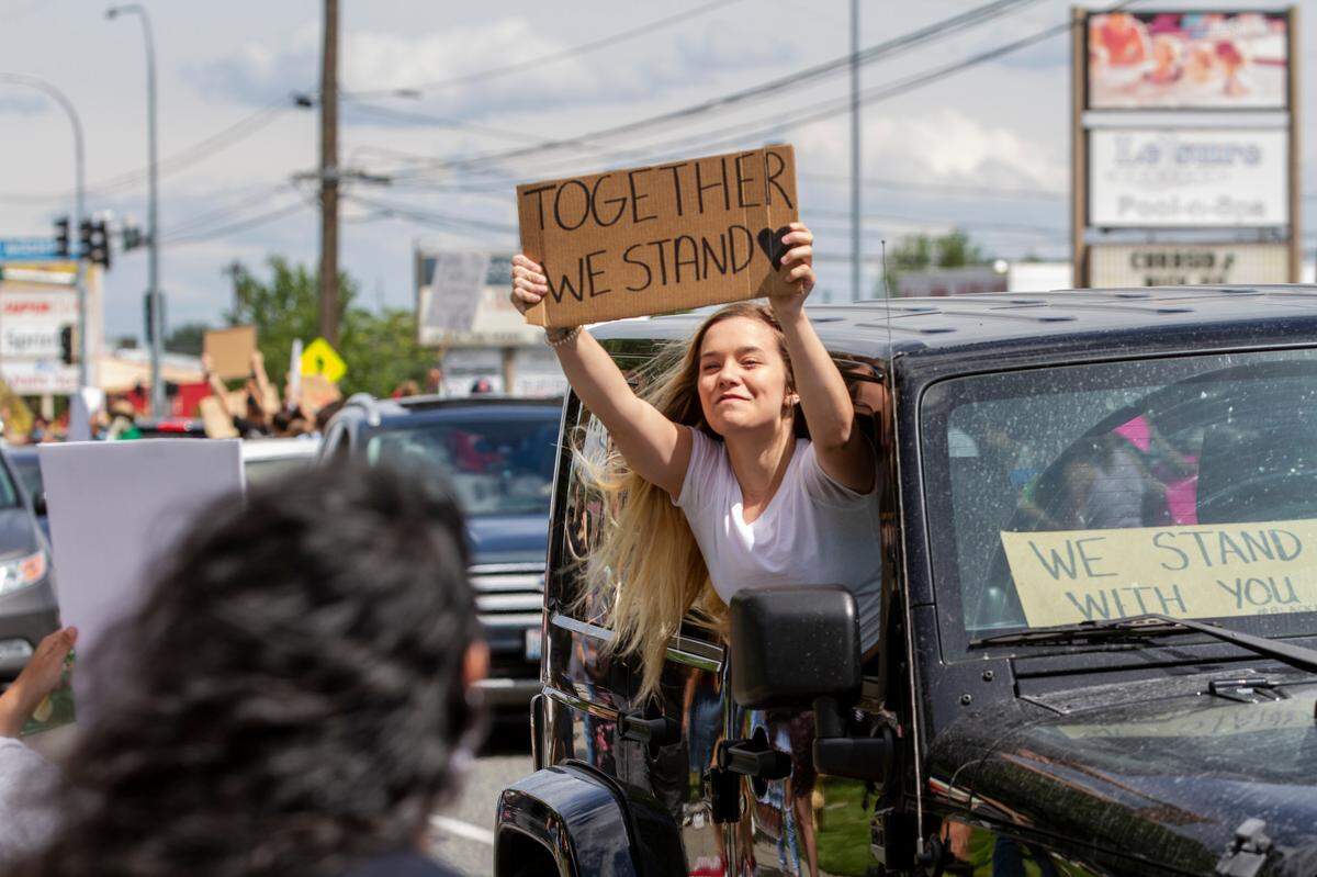 Some demonstrators gathered on the sidewalk outside of WinCo while others drove down West Clearwater Avenue, honking and waving signs to show their support for the peaceful protest against police brutality and violence against black people in Kennewick on Saturday.