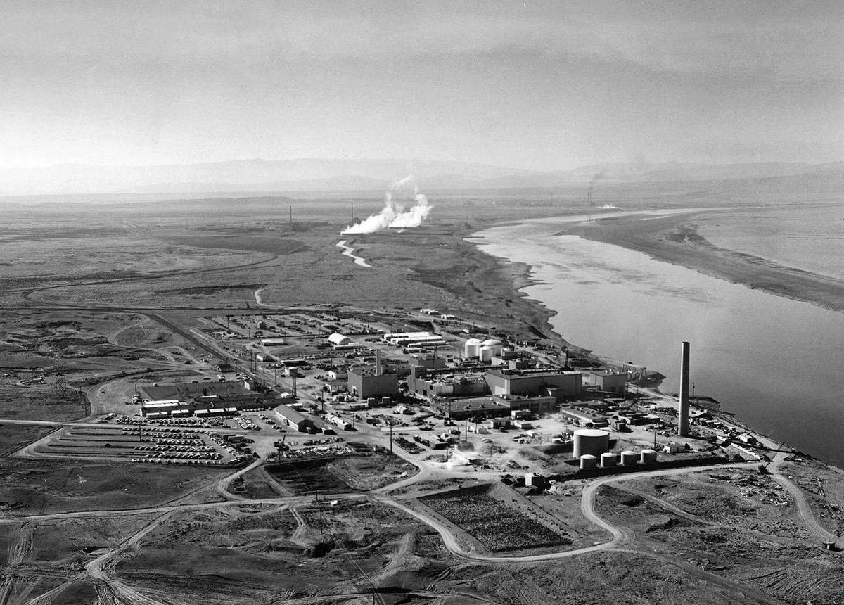 Nuclear reactors line the riverbank at the Hanford site along the Columbia River in January 1960. The site was chosen for its isolated location and proximity to the cold water of the Columbia, which were used to cool nuclear reactors.