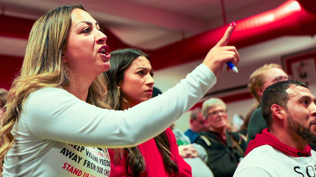 Janette Romero, neighborhood organizer, speaks out against a proposed sex offender house during a town hall meeting at Highlands Middle School. The crowd was estimated at 300.