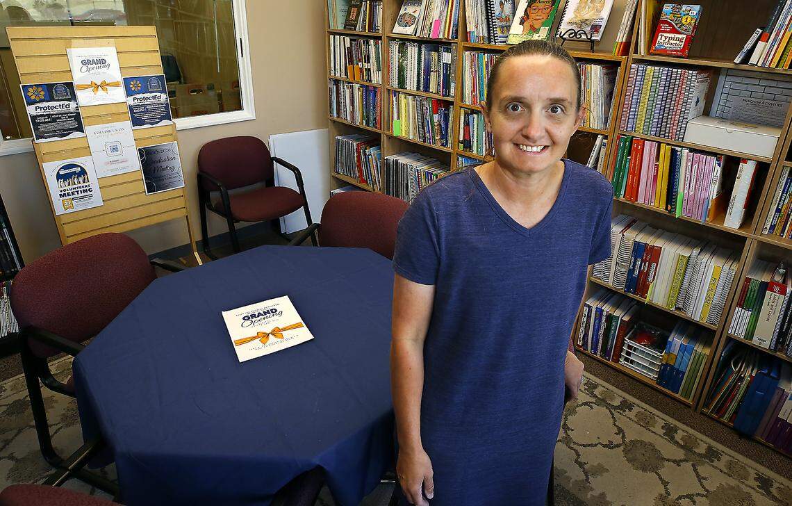 Laura Battles stands in the curriculum library section at the Teach the Children Homeschool Resource Center in West Richland.