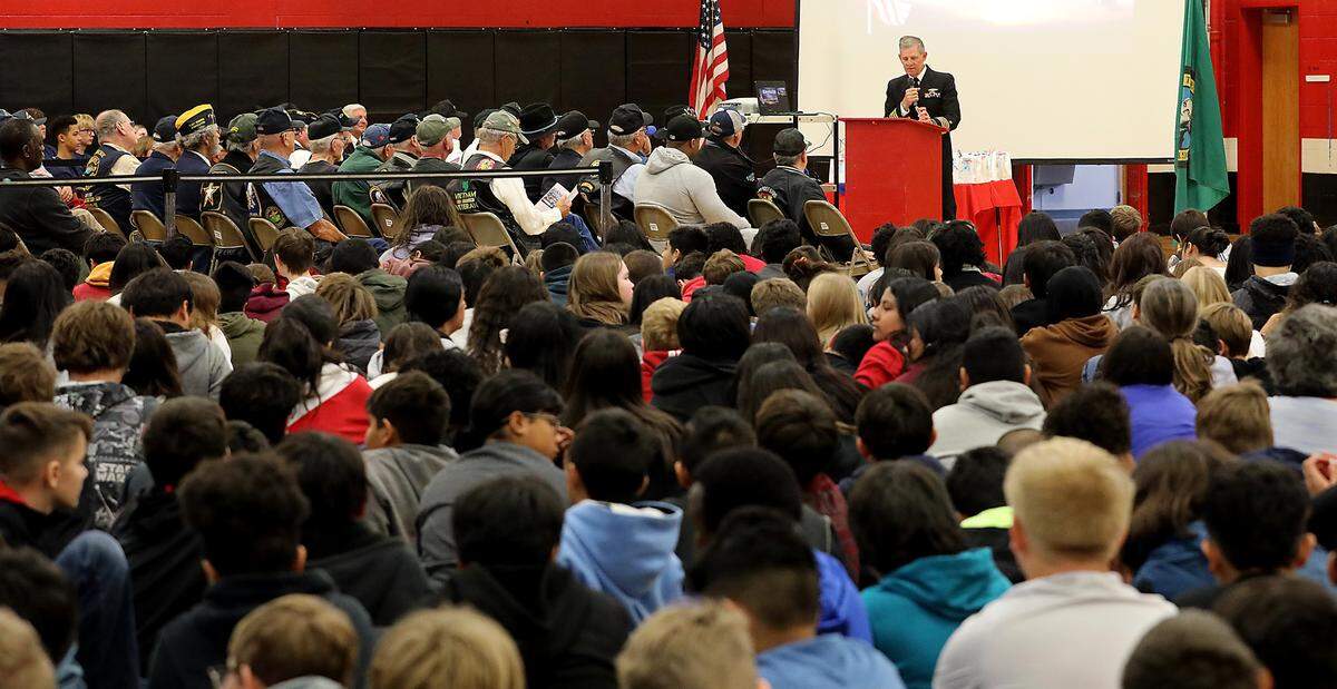 Retired submariner Capt. Ted Miller of Richland gives his keynote address to Highland Middle School students in the Kennewick school’s gymnasium at the school’s Military Appreication Day ceremony.