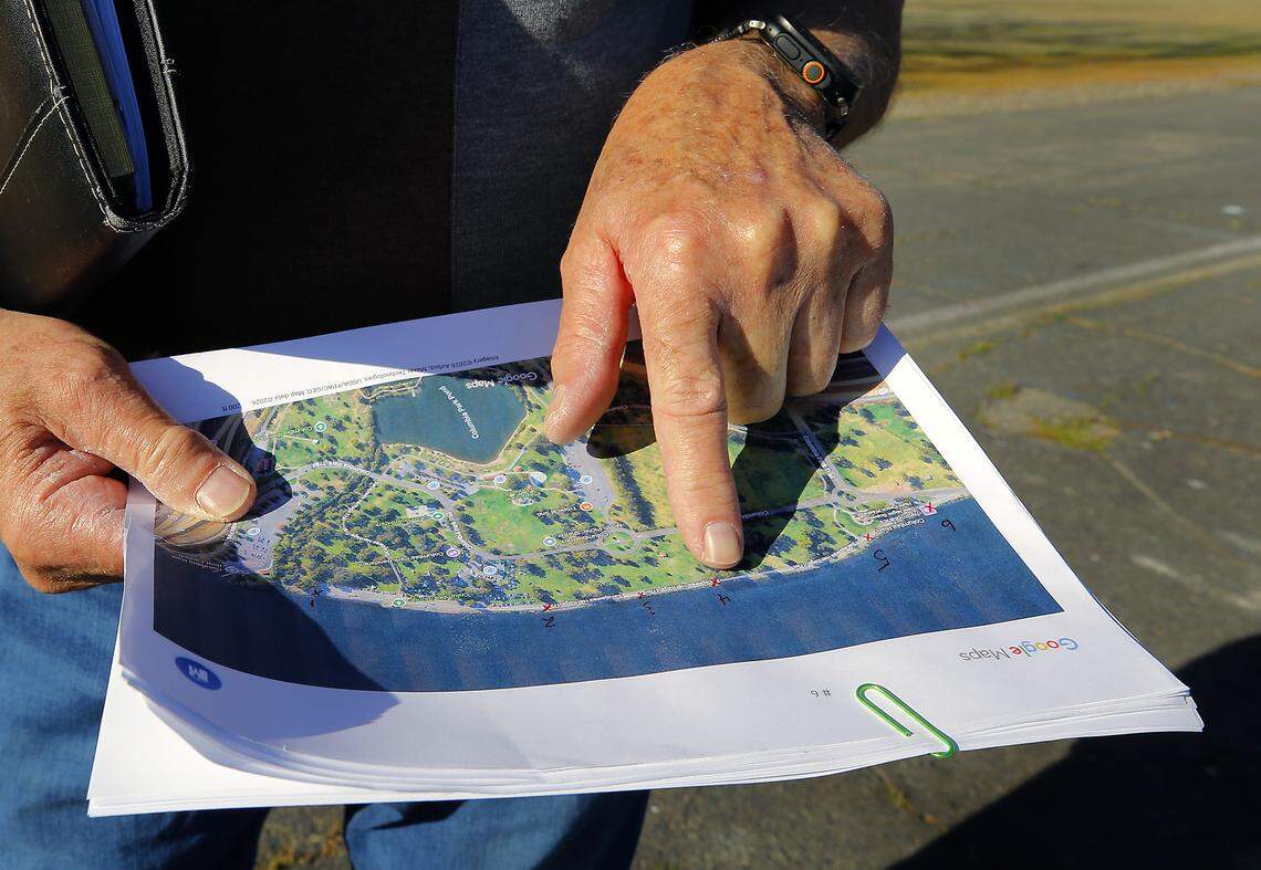Glenn points to a map he created to locate the stamps in Columbia Park in Kennewick. 