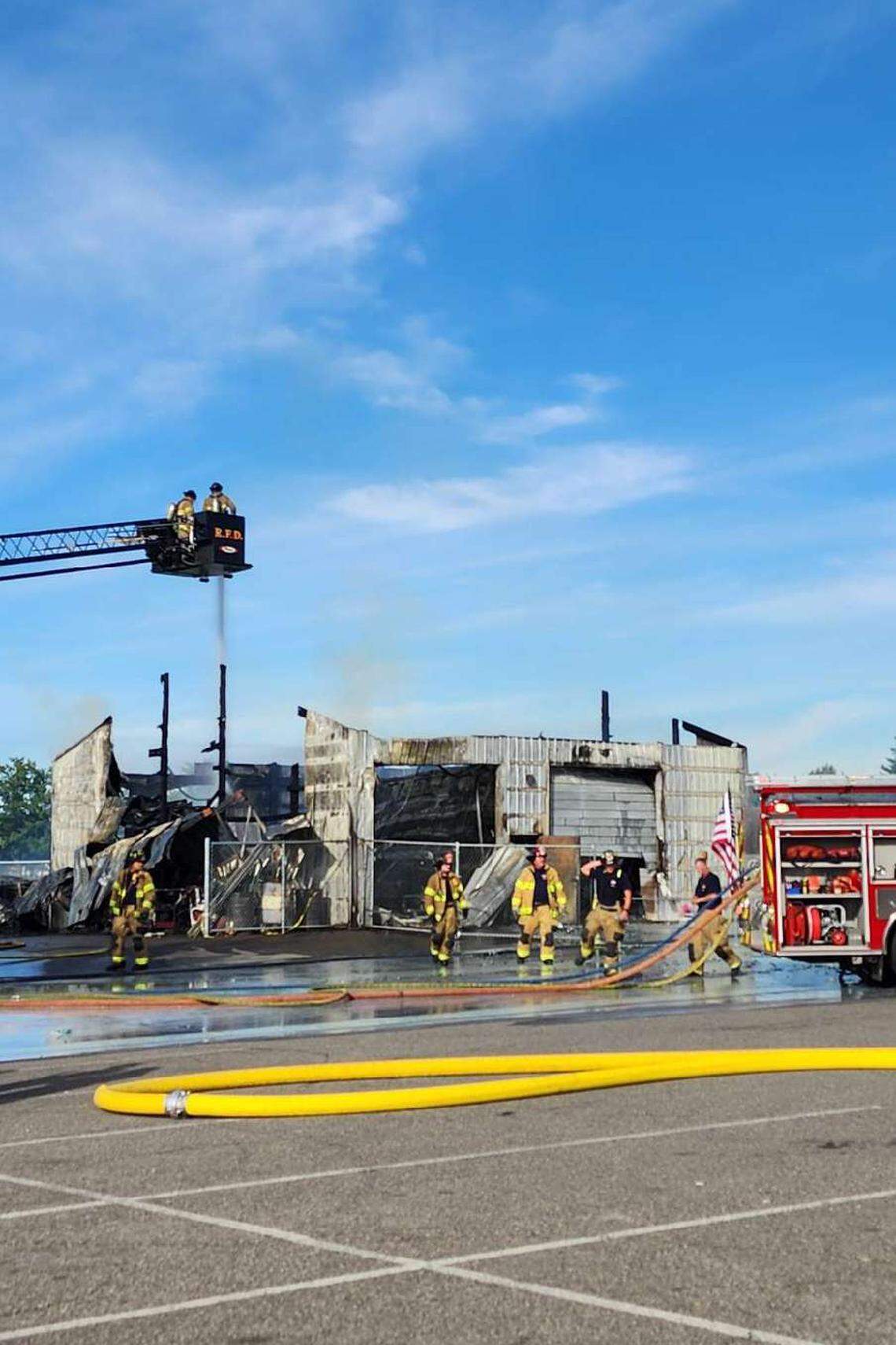 Hot spots from the fire that burned an outbuilding at Hanford High School in Richland Saturday reignited the fire Sunday, collapsing the building’s roof.