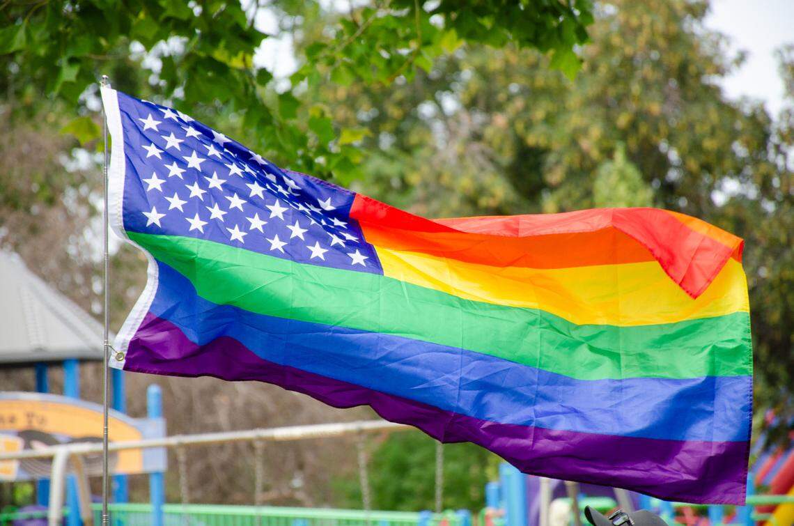 A gay pride version of the American Flag flies in Memorial Park in Pasco during the Tri-Pride 2023 gay pride festival. 