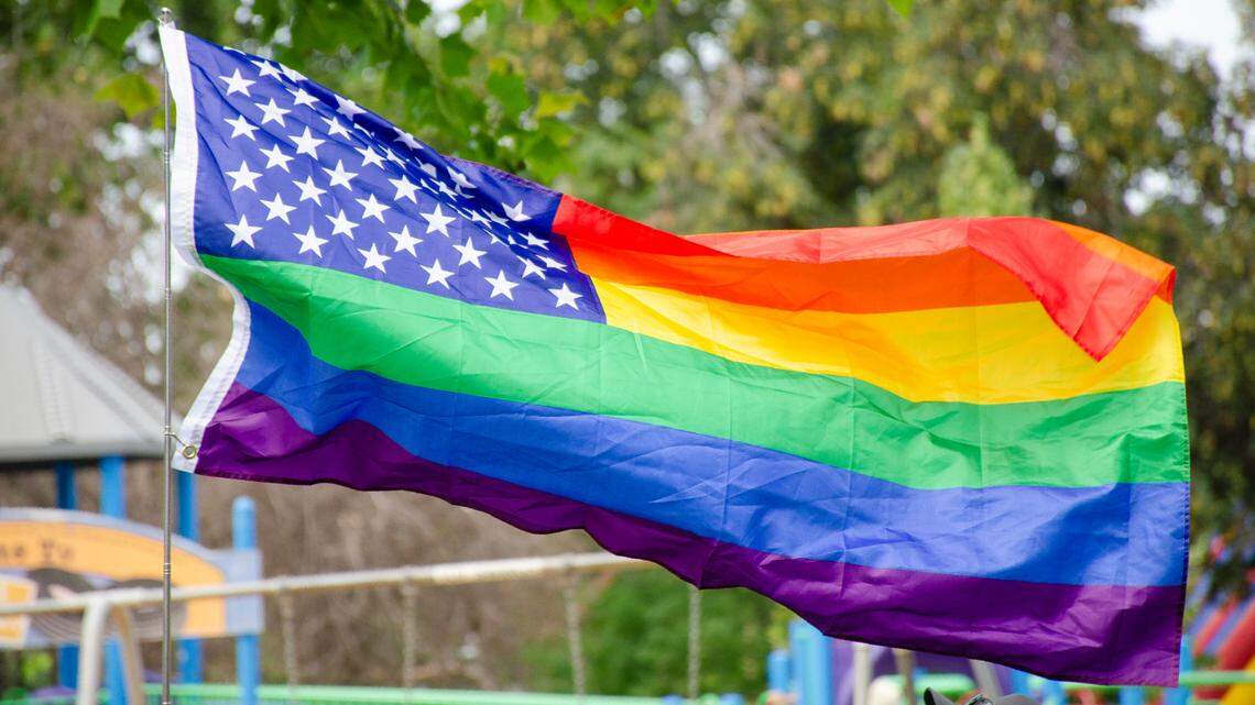 A gay pride version of the American Flag flies in Memorial Park in Pasco during the Tri-Pride 2023 gay pride festival. 