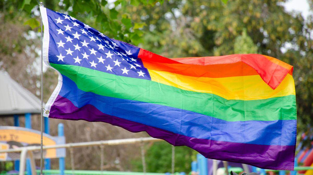 A Pride version of the American Flag flies in Memorial Park during the Tri-Pride 2023 festival.