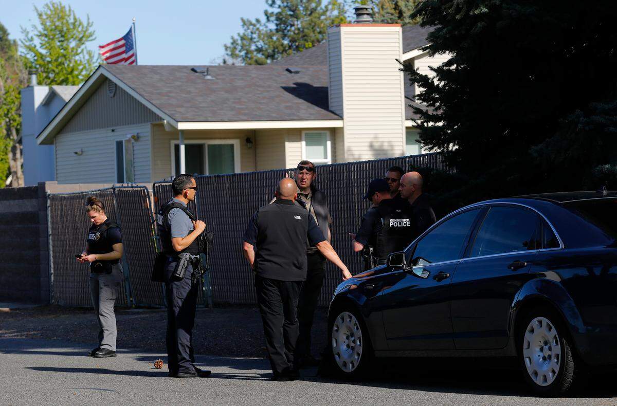 Police gather Tuesday afternoon near the 400 block of South Buchanan Street in response to a body found in a house.