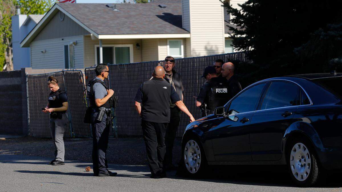 Police gather Tuesday afternoon near the 400 block of South Buchanan Street in response to a body found in a house.