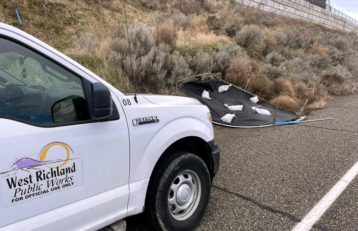 A trampoline that went flying in West Richland Tuesday was weighted down by city officials and left at the side of the road for its owner to find.