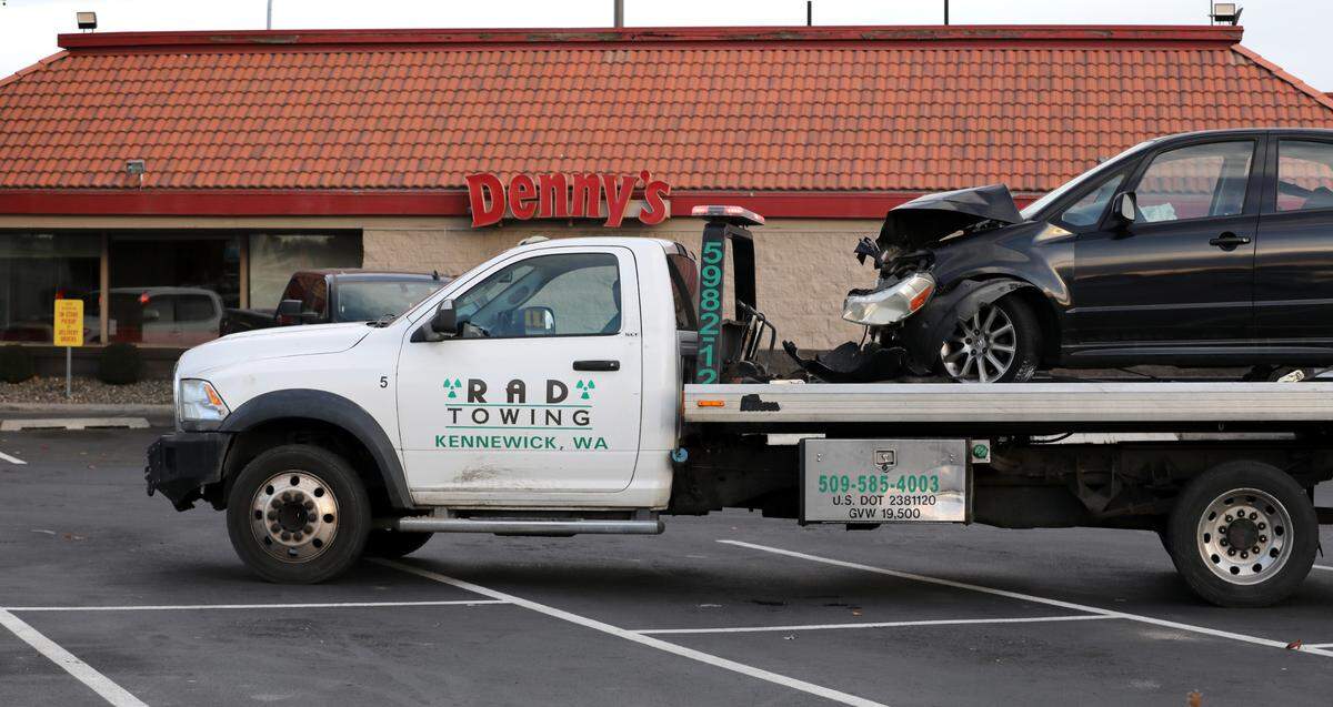 A heavily damaged Suzuki sedan involved in Monday’s two vehicle collsion at the intersection of Highway 395 and West Kennewick Avenue sits on a tow truck in the the Denny’s. The car’s driver and passenger were taken to a local hospital.
