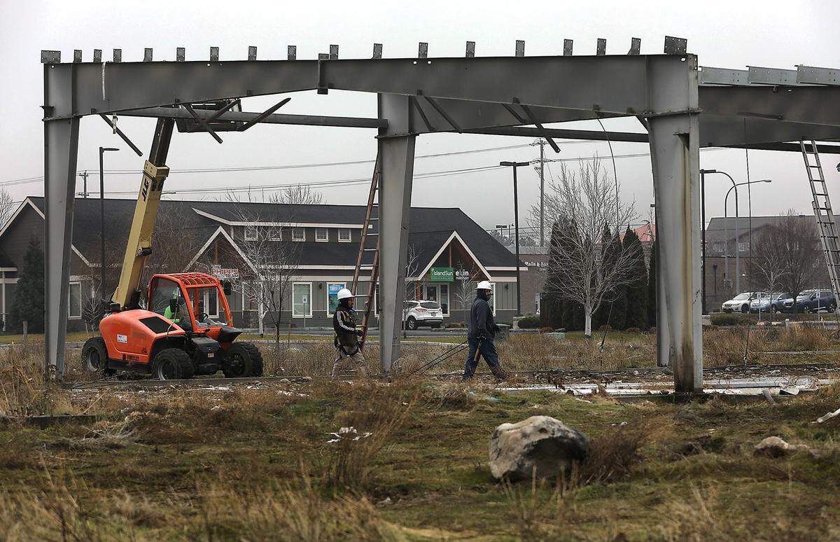 Workers remove a partial steel building and foundation at 2404 S. Quillan Place to make way for new development. The structure was part of an abandoned restaurant project, “Catch and Release Sports Bar.”