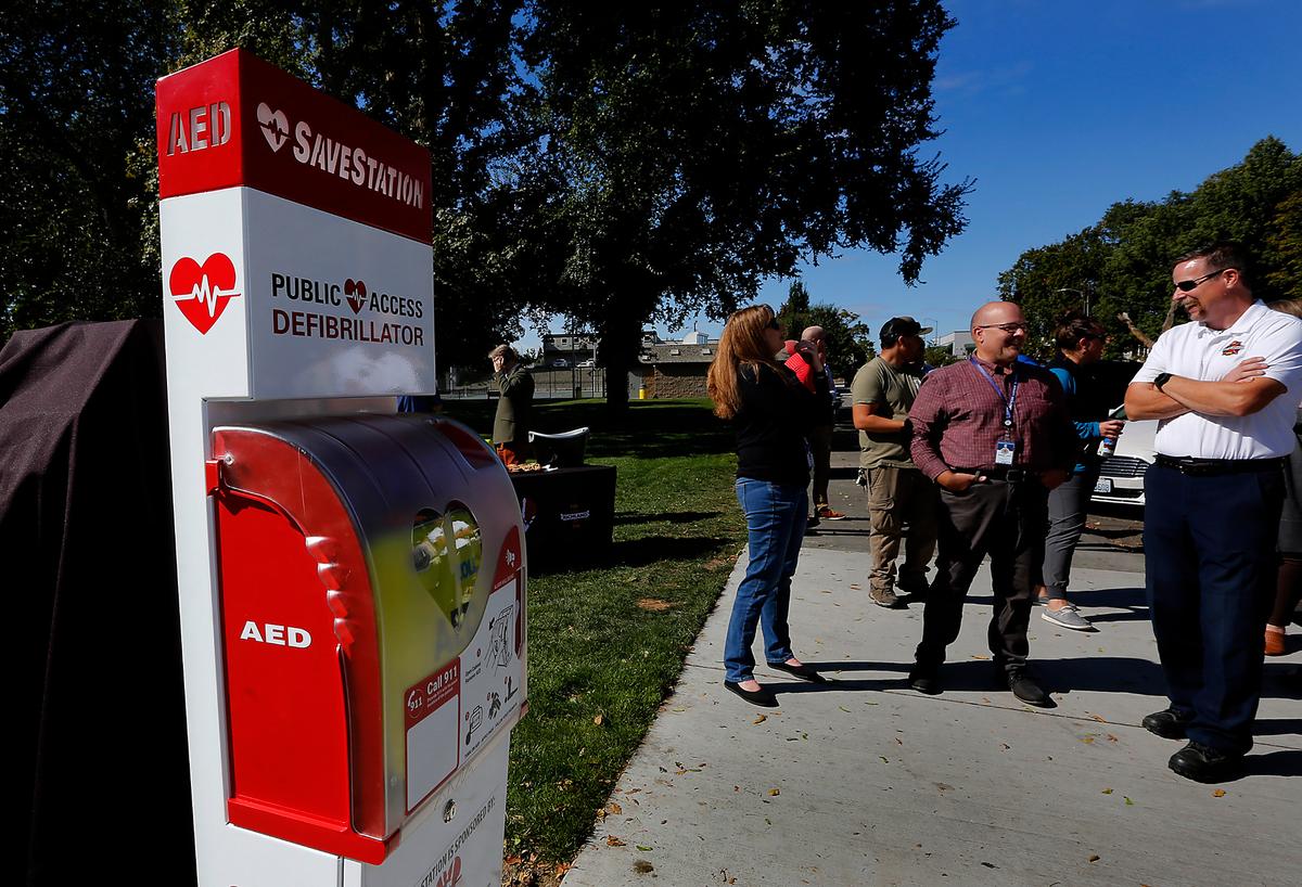 A crowd gathers near the new SaveStation in Richland’s Howard Amon Park, featuring the first public access heart defibrillator. The 24/7 accessible AED is part of the Heart Safe Richland initiative to improve the chances of survival for people who experience sudden cardiac arrest.&nbsp;The life-saving device includes a GPS tracker and hands-free communication with emergency medics.