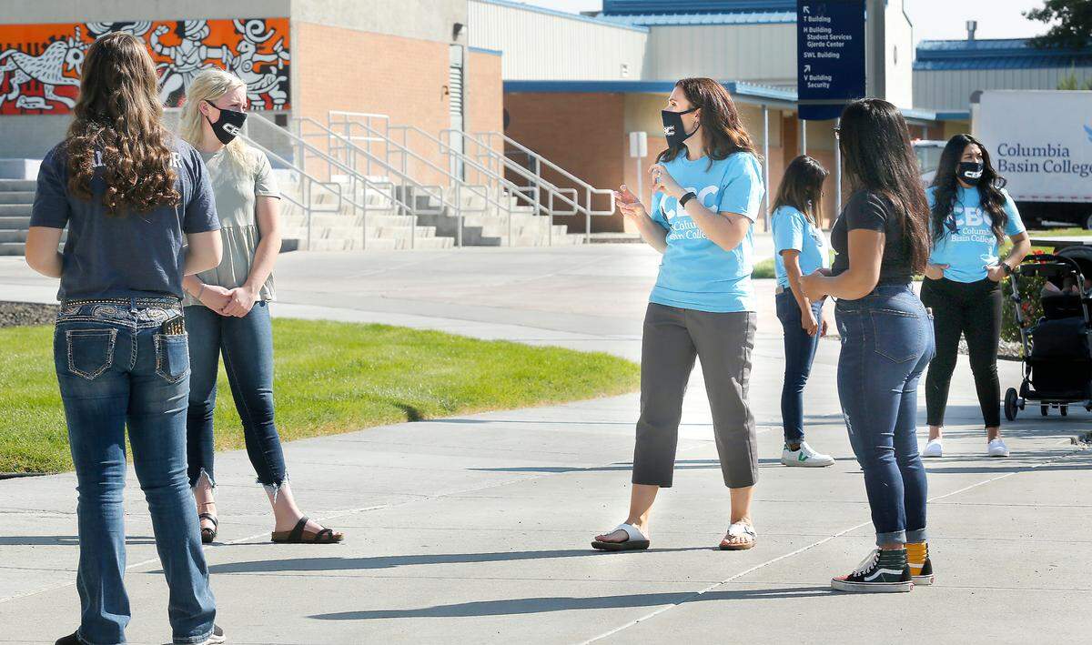 Melanie Casciato, center, offers tips about giving campus tours to the newest group of student ambassadors at the Pasco campus of Columbia Basin College. Casciato, director for student recruitment, said the ambassador’s role is even more crucial during the ongoing coronavirus pandemic. Watch a video at: tricityherald.com/videos.