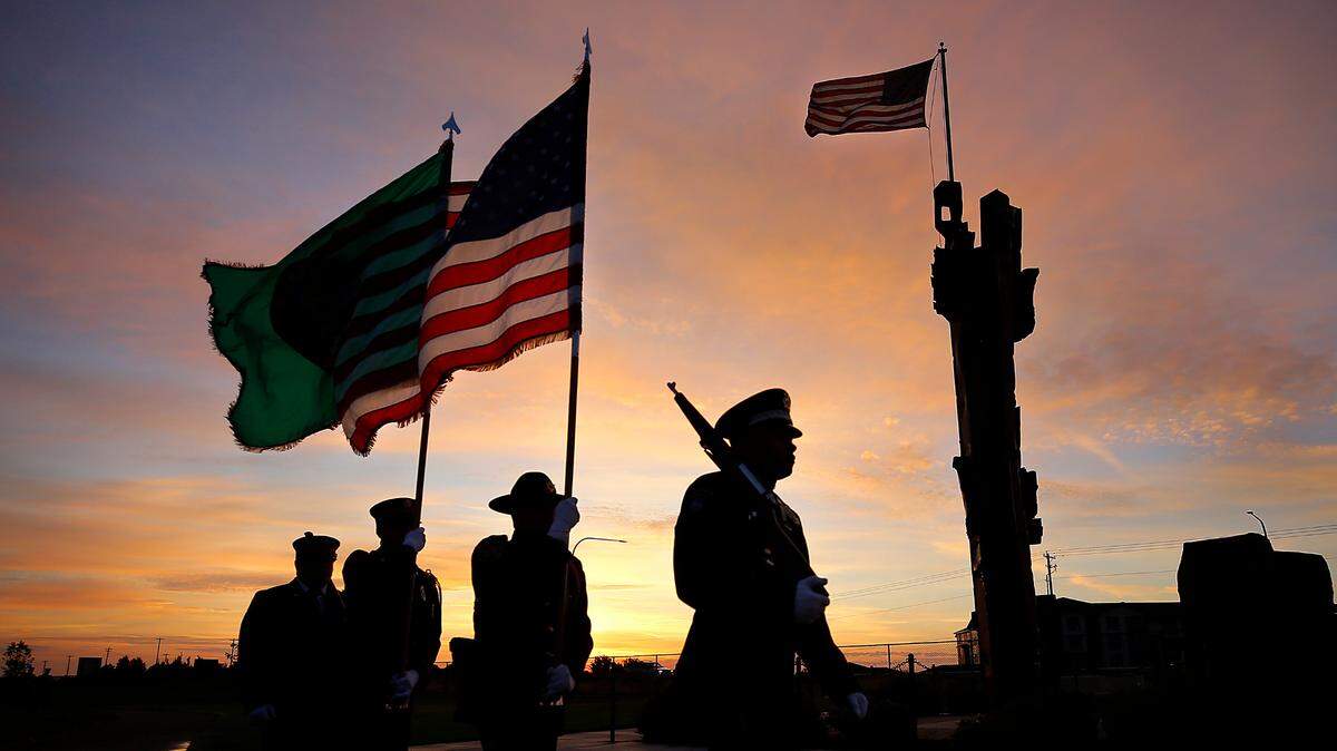 The Tri-Cities Professional Firefighters Honor Guard present the colors at Monday’s sunrise over the 9/11 memorial at the Southridge Sports and Events Complex in Kennewick. The Honor Guard, including members of the Kennewick Police Department and Benton County Sheriff’s Office, paid respects to those killed during the terrorist attacks in 2001. The 22nd remembrance ceremony was near the 3-ton, 35-foot piece of steel from the destroyed World Trade Center towers.