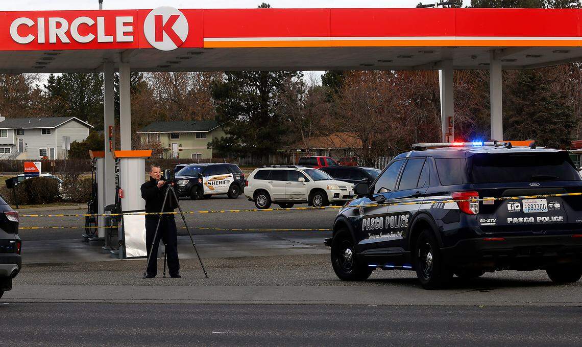 Investigators document the scene on Friday’s early morning shooting of a Pasco police officer in the parking lot of the Circle K gas station and convenience store on West Court Street at Road 32.