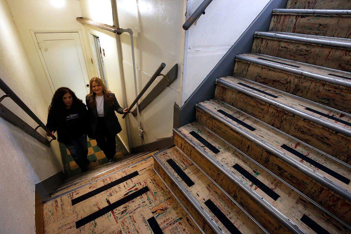 Client Diane Alaniz, left, and shelter manager April Biondolillo climb the steep stairs used to reach the dining area at the women’s shelter.