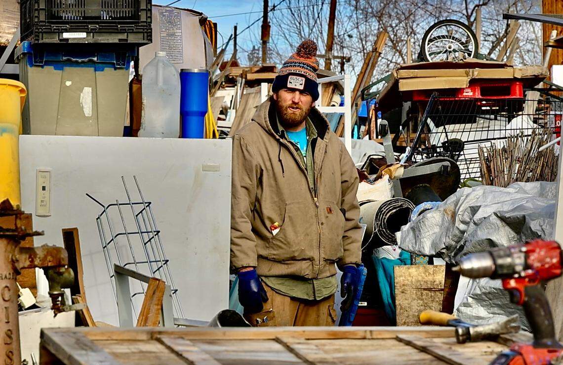 Taylor Knipp stands outside his home at 2100 Pullen St. in Richland on Jan. 7, 2026. Knipp is in the middle of a legal fight with the city over the “mountain of debris” that has engulfed his property.