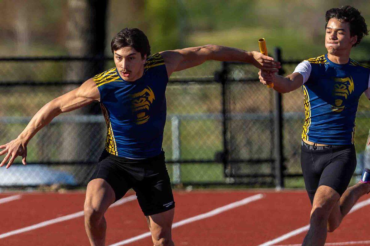 Southridge High School relay team members hand off the baton at a track and field meet on March 26.