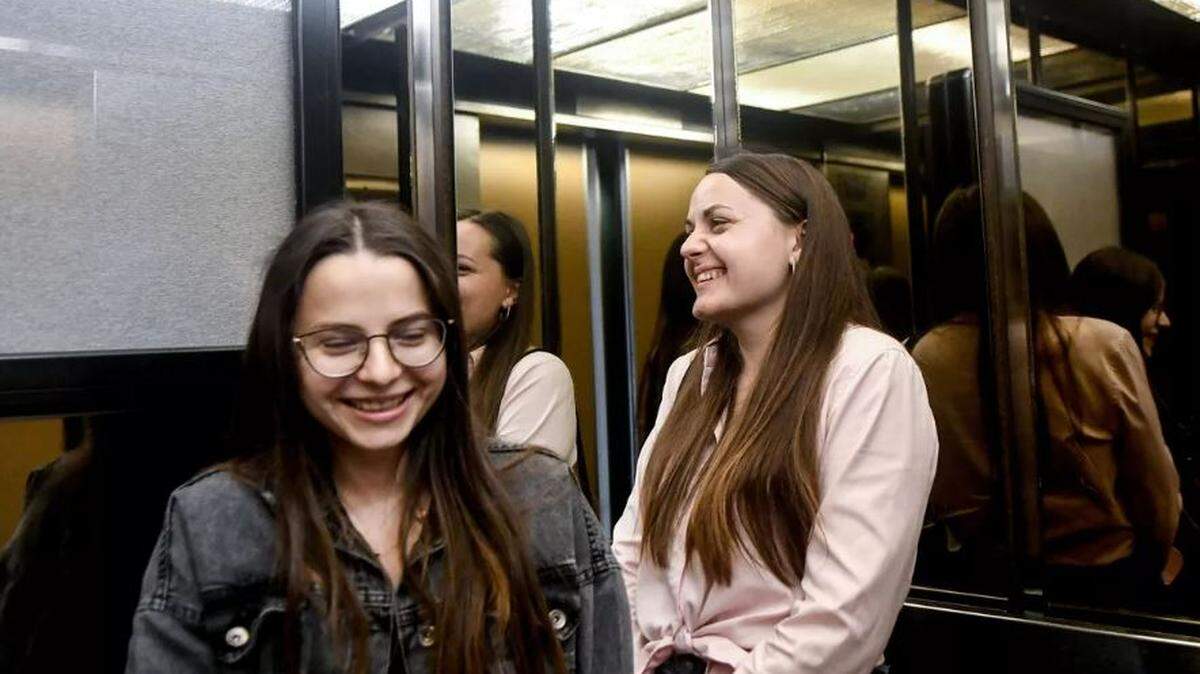 Ukrainian refugee sisters Olena Nikora, left, and Yelyzaveta Nikora share a laugh in the elevator on their way to see their new hotel rooms as part of Thrive International’s refugee housing program, Thrive Center, in Spokane on Wednesday.